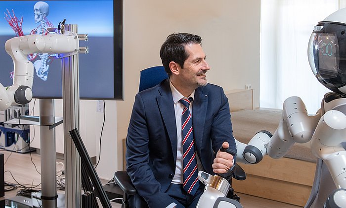TUM-Präsident Thomas F. Hofmann mit Roboter-Assistent GARMI