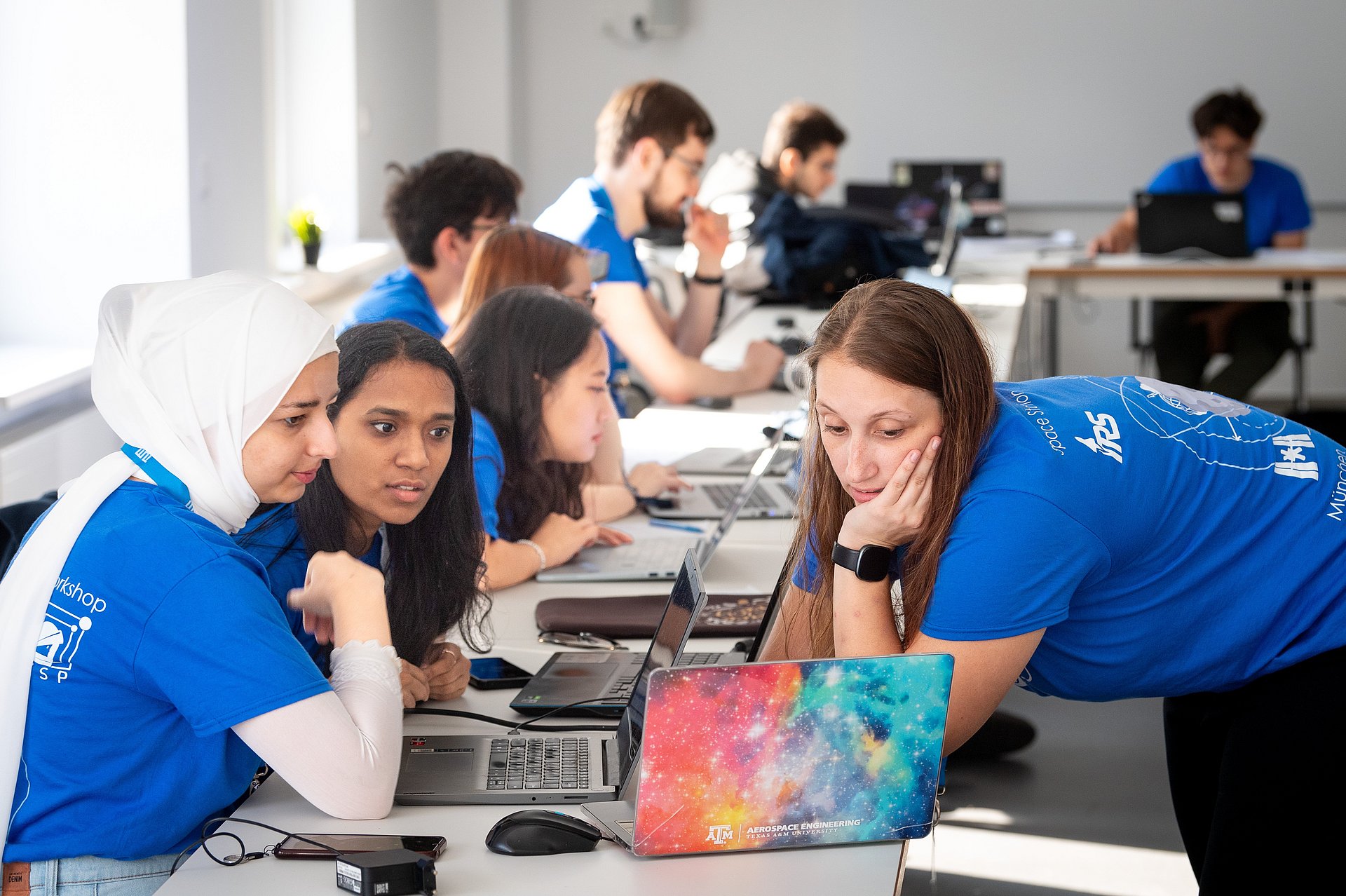 Three participants work on their presentation