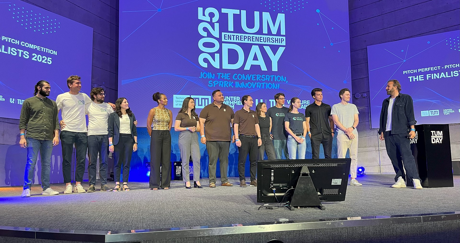 Group of people on stage at pitch competition