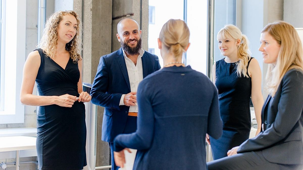 Gruppe von Menschen in Business-Kleidung, die sich unterhalten