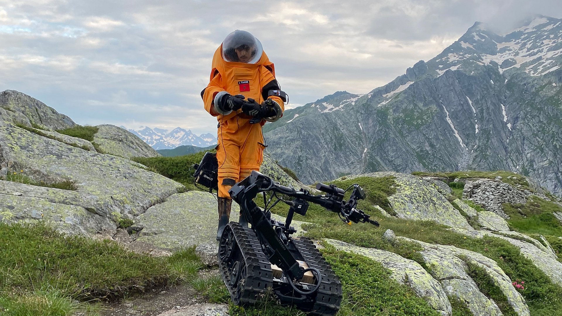 A student astronaut steering a mond rover over rocky landscape