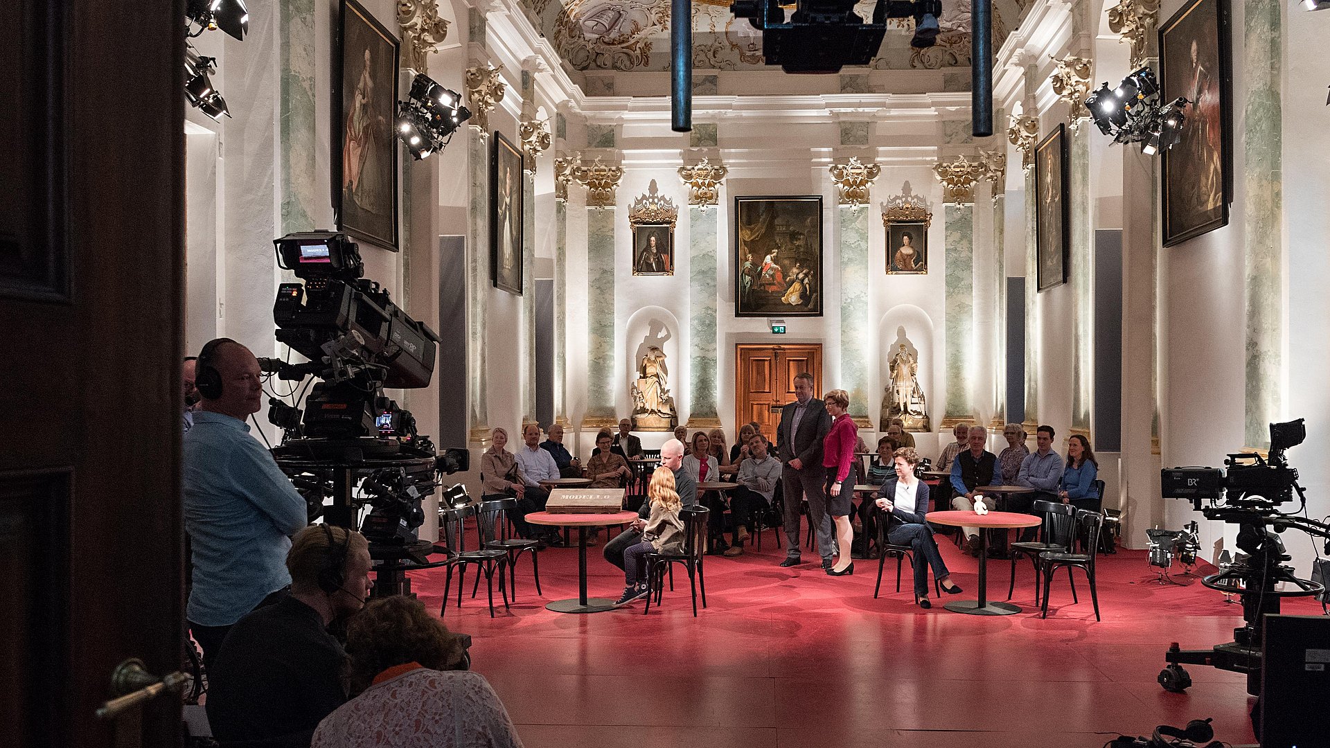 Cameras are filming a show in one of the academy rooms.