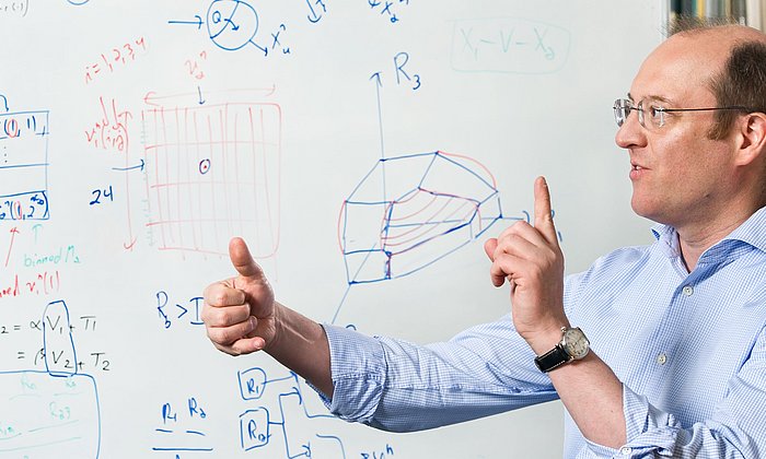 Prof. Gerhard Kramer at a whiteboard at his chair