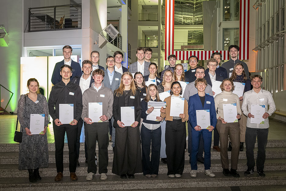 Group photo with scholarship holders. They hold the certificates in their hands.