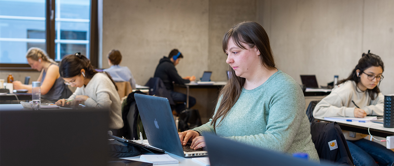 TUM student Sandra Paßreiter works on her laptop in a study area.